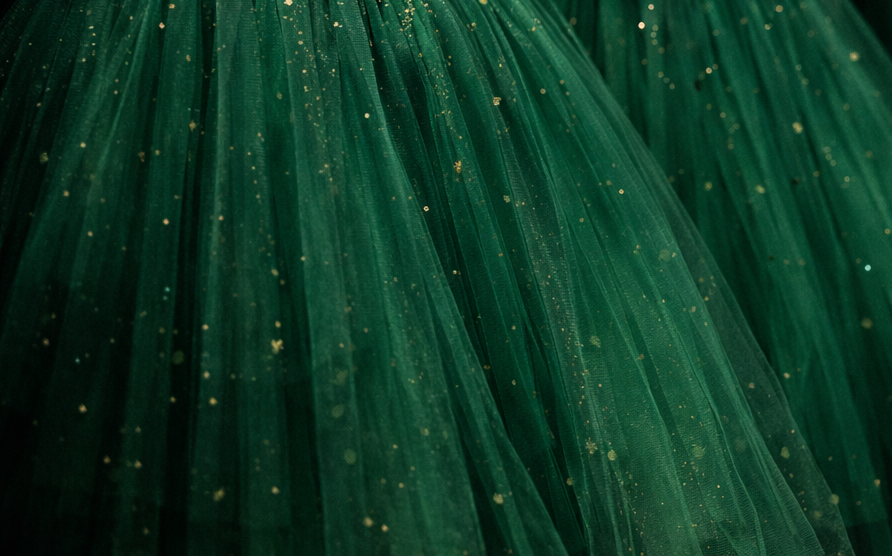 Closeup of emerald green tulle skirts with gold sparkles